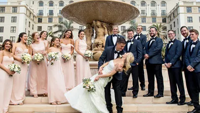 A wedding photo with all the groomsmen and bridesmaids